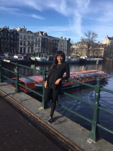 Maria Amupolo on her travels through Europe, standing at one of Amsterdam’s canals.